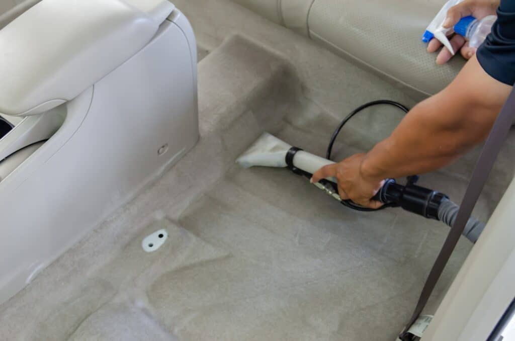 Car Details - Cleaning car carpets with antiseptic and vacuuming carpets.
